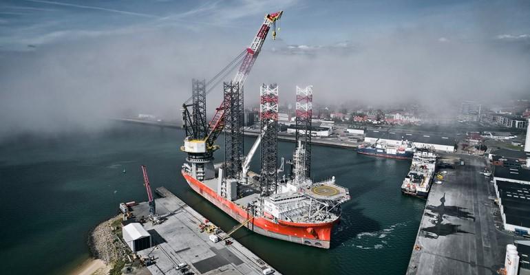 Cadeler's pacific osprey vessel with a new crane boom in the port of esbjerg