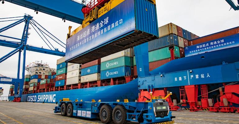 A Cosco Shipping vessel loads a container in Quanzhou Port.