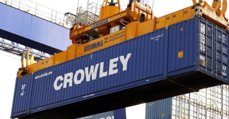 Crowley container being loaded onto a vessel