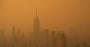 A view of the New York City skyline obscured by orange haze
