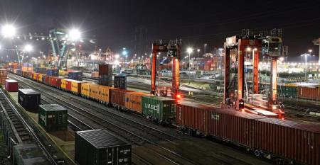 Containers in a lit rail yard at night